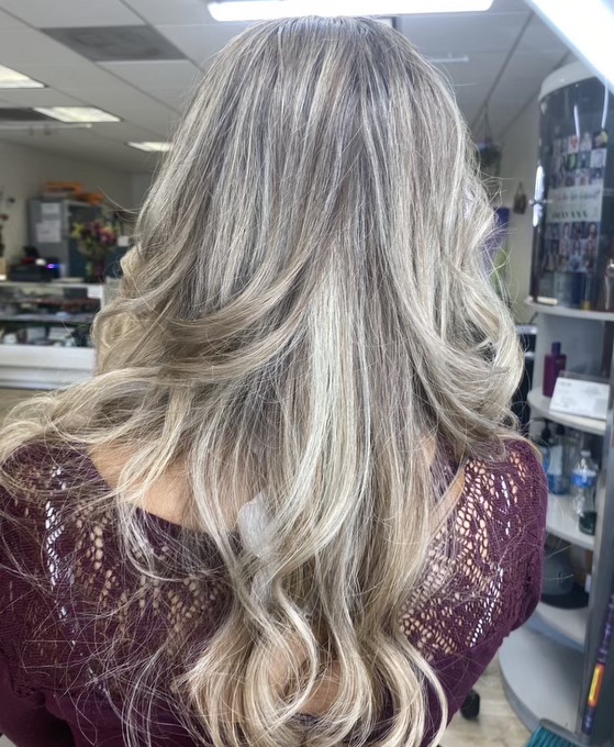 view of woman's haircut from behind with wavy blond and brown hair