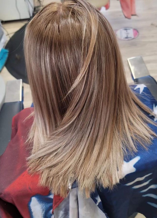 Blond hair with blond tips. Distressed edges type of hair cut